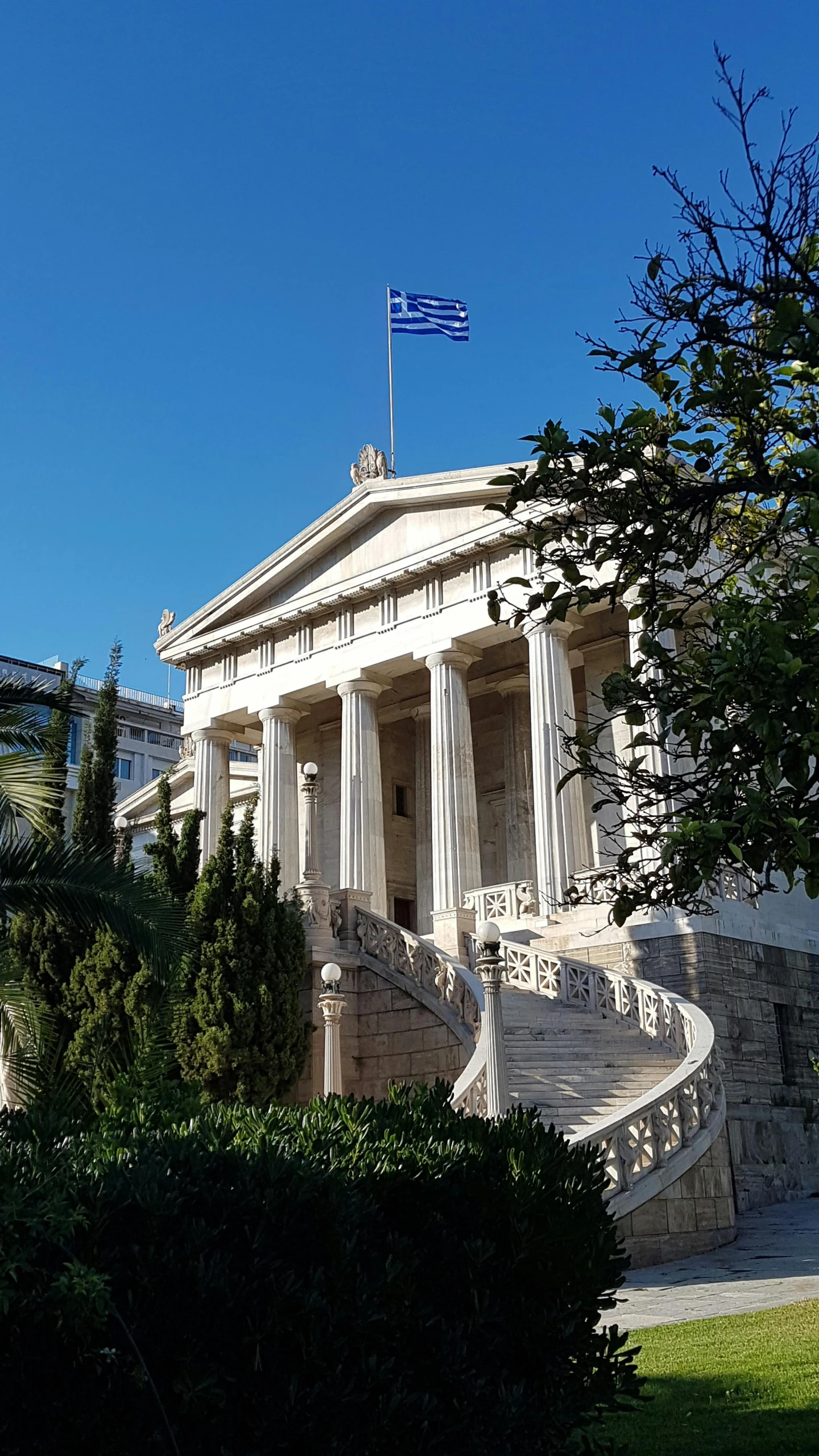 a building with a flag on top of it, by Nassos Daphnis, neoclassicism, grand library, promo image, overview, entrance