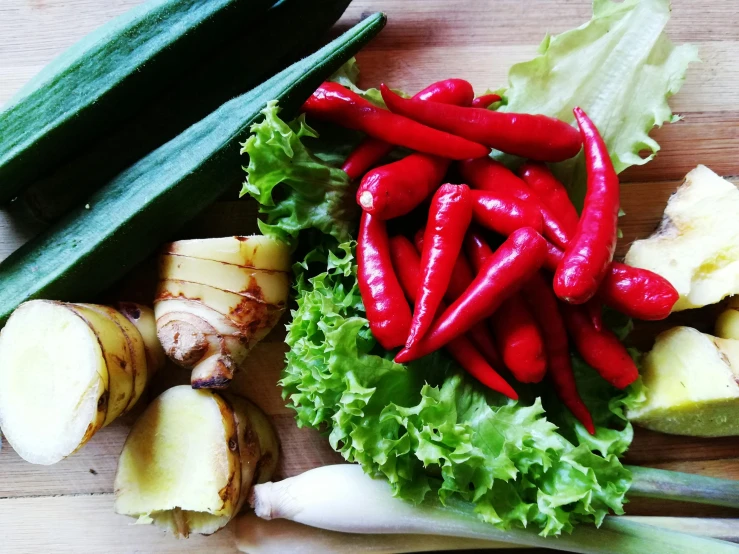 a bunch of vegetables sitting on top of a wooden table, inspired by Géza Dósa, malaysian, no cropping, teaser, spicy