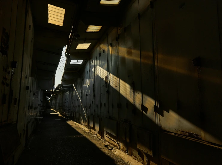 the sun shines through the windows of a train car, inspired by Elsa Bleda, liminal space hallway, inside a warehouse, photo taken from a boat, photograph taken in 2 0 2 0