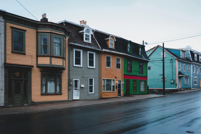 a row of houses sitting on the side of a road, by Carey Morris, pexels contest winner, renaissance, muted neon colors, gauthier leblanc, 1910s architecture, unsplash photo contest winner