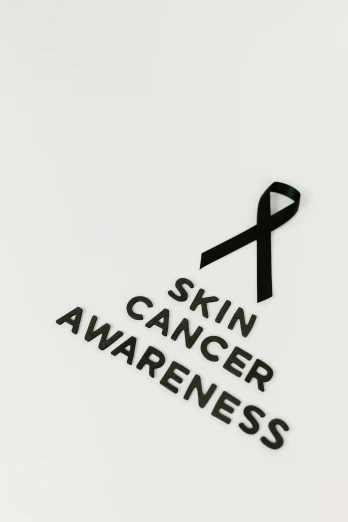 a black ribbon with the words skin cancer awareness on it, an album cover, trending on pexels, skincare, 240p, profile picture, human skin