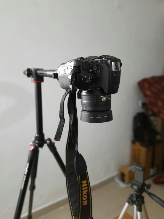 a camera sitting on top of a tripod next to a camera, by Mathias Kollros, low quality photograph, 8 k image