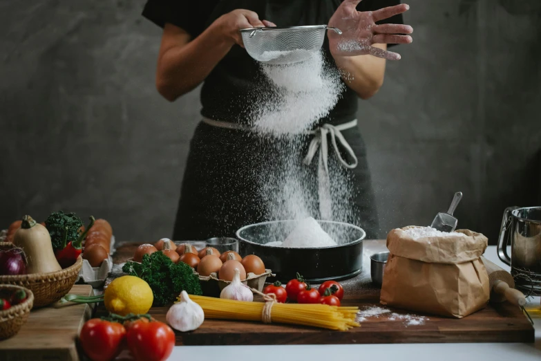 a woman is sprinkling flour into a bowl, pexels contest winner, avatar image, background image, chef table, italian