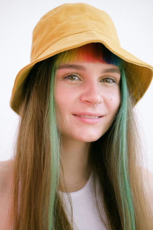 a woman with green hair wearing a yellow hat, a colorized photo, inspired by Elsa Bleda, trending on pexels, brown hair with light blue ends, colorful]”, teenage girl, ((greenish blue tones))
