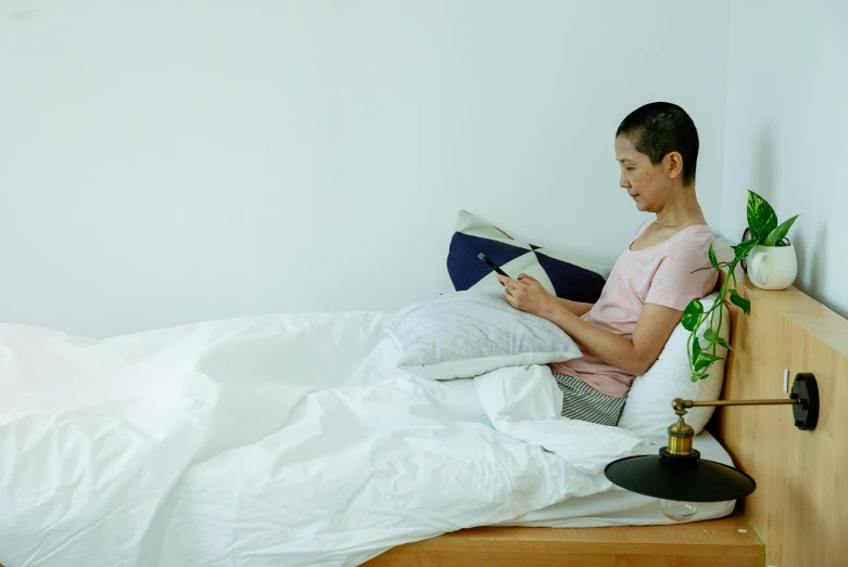 a woman laying in bed reading a book, happening, japanese collection product, slightly minimal, profile image, cushions