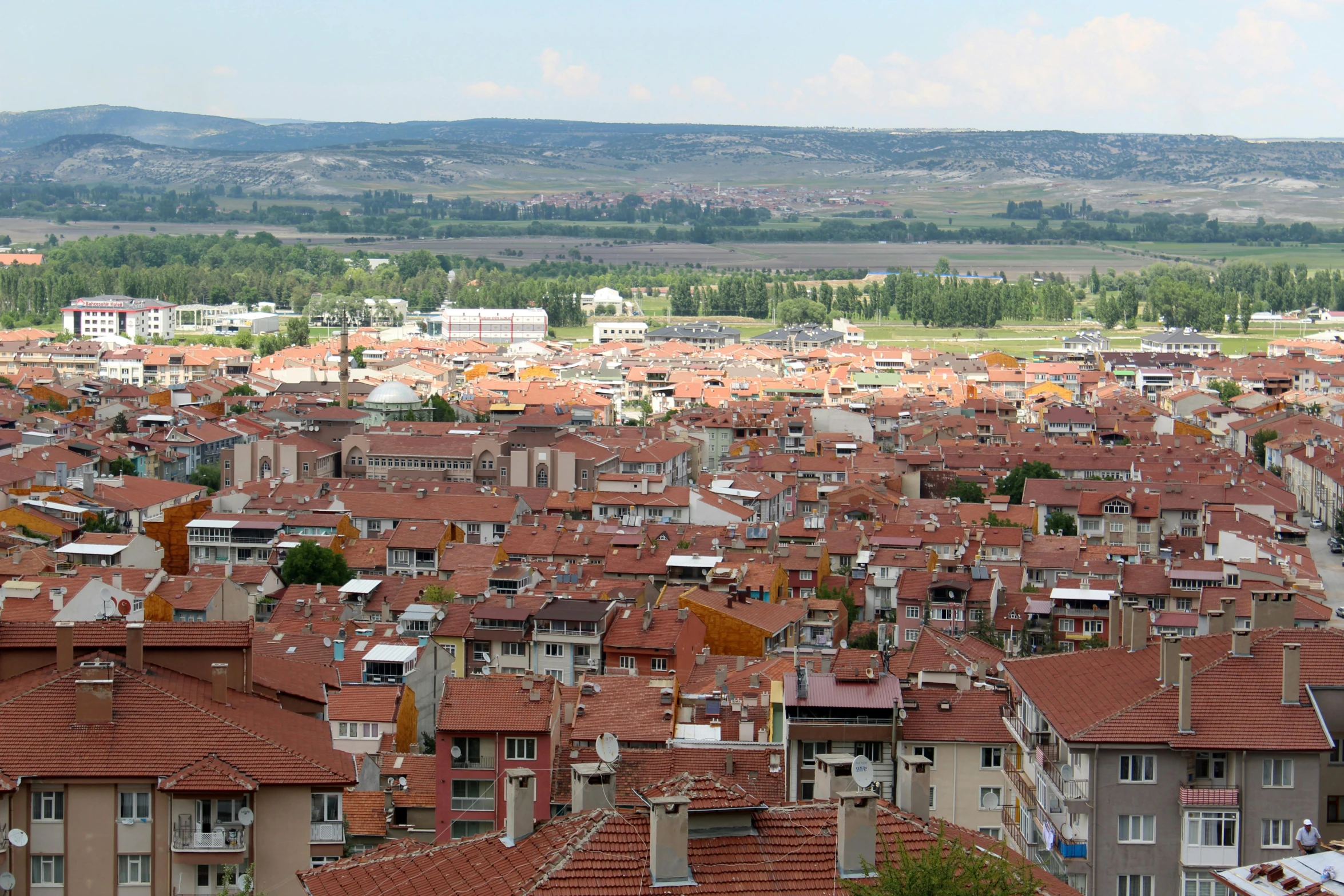 a view of a city from the top of a hill, by Yasar Vurdem, orange roof, slide show, quaint, csok istvan