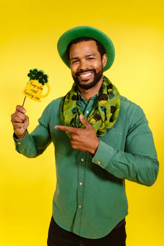 a man in a green shirt and a green hat, a photo, shutterstock contest winner, yellow backdrop, clover, photo booth, diverse