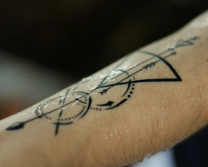 a close up of a person's arm with a tattoo on it, a tattoo, intricate mathematical shape, set photo