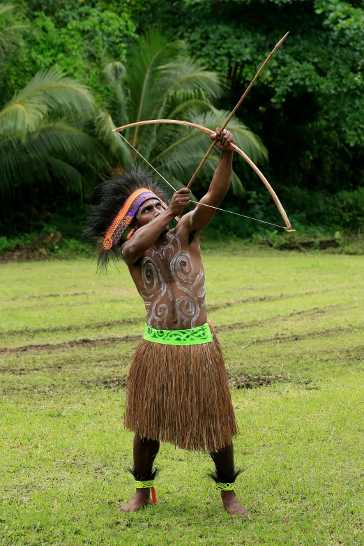 a man that is standing in the grass with a bow, tribal dance, in a jungle, aiming a bow and arrow, slide show
