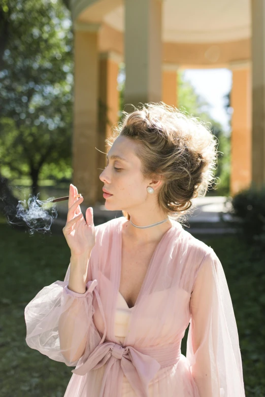 a woman in a pink dress smokes a cigarette, a colorized photo, inspired by Konstantin Somov, unsplash, renaissance, hair styled in a bun, (smoke), promo image, chaumet