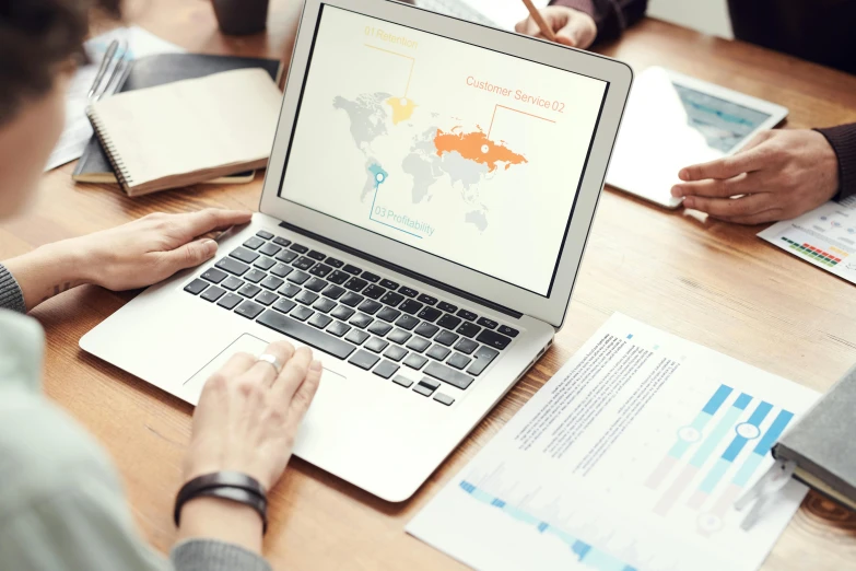 a group of people sitting around a table with a laptop, a digital rendering, by Adam Marczyński, trending on unsplash, cartographic, background image, 9 9 designs, infographics. logo