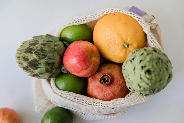 a bag of fruit sitting on top of a table, by Nicolette Macnamara, pexels, natural skin, 🦩🪐🐞👩🏻🦳, frontal shot, products shot