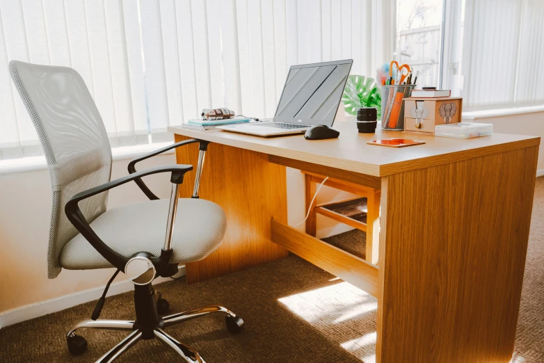 a laptop computer sitting on top of a wooden desk, sitting on a chair, office furniture, thumbnail, doctors office