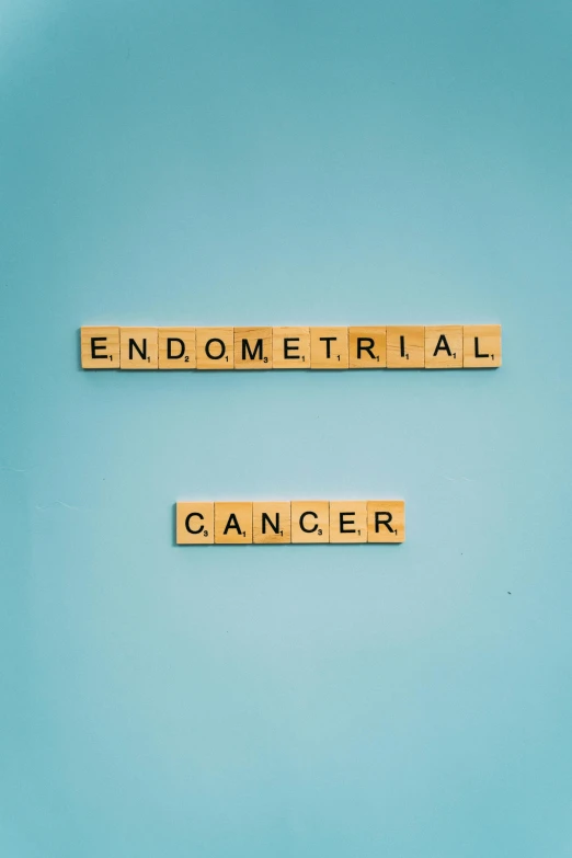 scrabbles spelling endometrial cancer on a blue plate, an album cover, molecular, gray, 1x, robotical