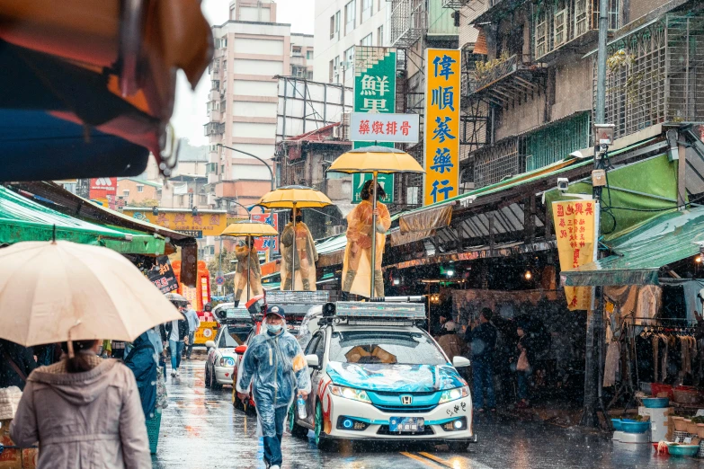 a group of people walking down a street holding umbrellas, guan yu, cars parked underneath, wet market street, top selection on unsplash