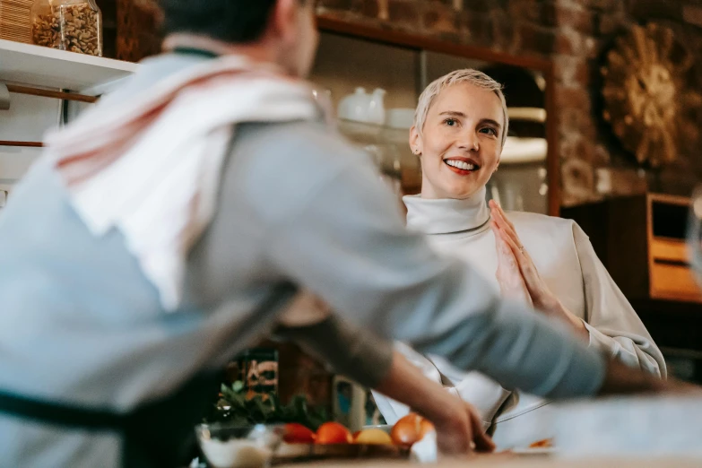 a woman standing next to a man in a kitchen, pexels contest winner, happening, man in silver space suit, happy chef, aussie baristas, wearing a turtleneck and jacket