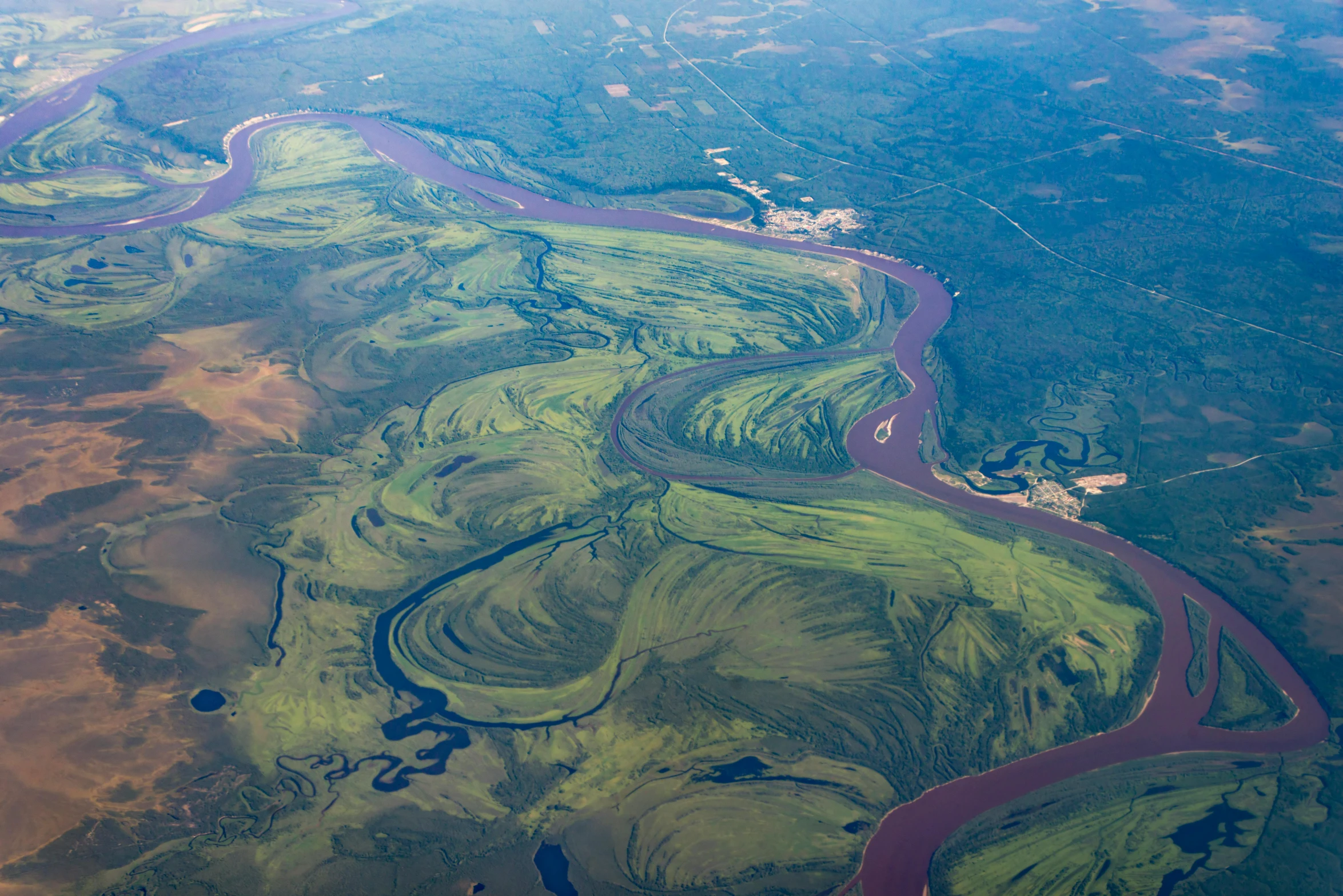 an aerial view of a river running through a valley, by Jessie Algie, river delta, green slime, neo norilsk, thumbnail