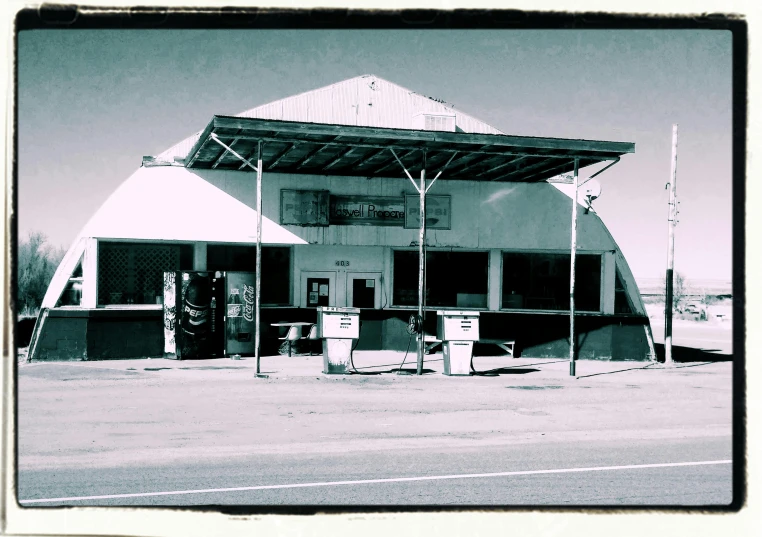 a black and white photo of a gas station, by Lee Loughridge, pop art, “ iron bark, ((oversaturated)), square, sunfaded