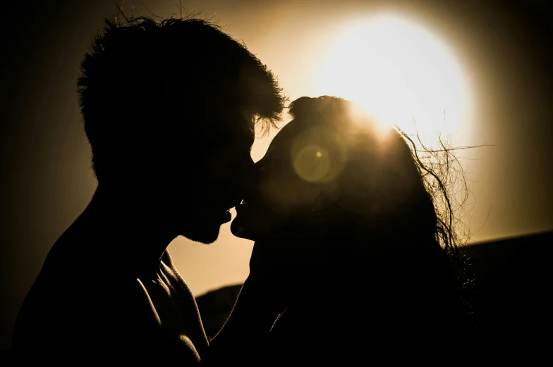 a man and a woman kissing in front of the sun, pexels contest winner, backlit ears, attractive man, profile image, 1 2 9 7