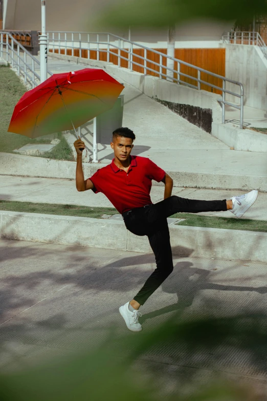 a man in a red shirt is holding an umbrella, an album cover, inspired by Byron Galvez, pexels contest winner, classic dancer striking a pose, non binary model, kickflip, 15081959 21121991 01012000 4k