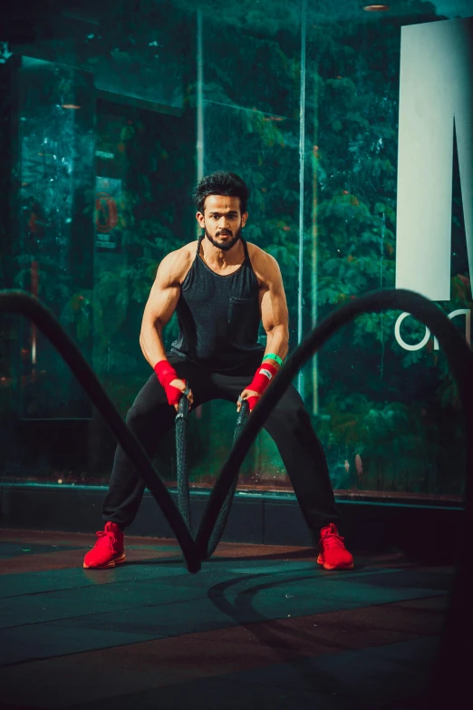 a man sitting on a rope in a gym, pexels contest winner, bollywood, spiky, wearing fitness gear, square