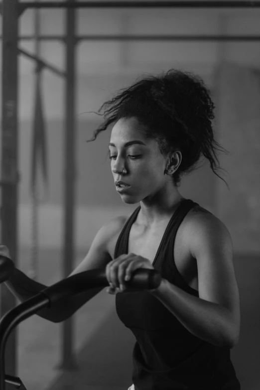 a black and white photo of a woman on a stationary bike, pexels contest winner, ashteroth, sweating intensely, oona chaplin, athletic crossfit build