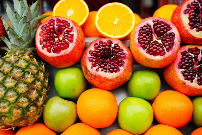 a pile of fruit including oranges, apples, and pineapples, by Carey Morris, pexels, pomegranade, orange and turquoise ans purple, wide screenshot, healthy