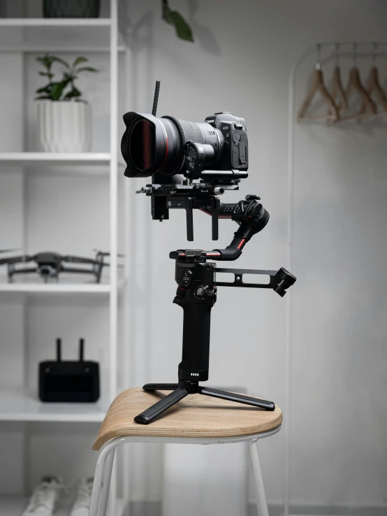 a camera sitting on top of a wooden chair, a portrait, extended robotic arms, detailed product image, phantom grip, long shot from back