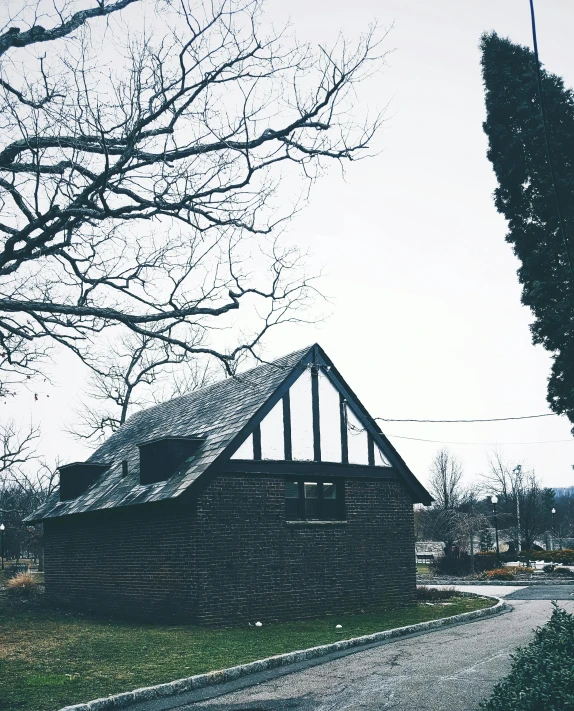 a small brick building sitting on the side of a road, by Lucia Peka, unsplash, barbizon school, cementary, black house, bathhouse, upon a peak in darien