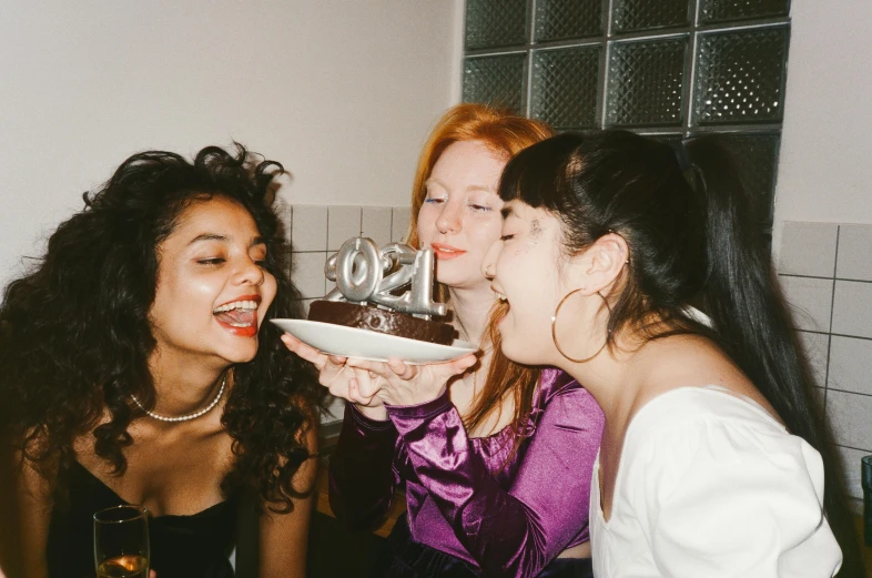 a group of women standing around a cake, inspired by Nan Goldin, trending on pexels, renaissance, making the best smug smile, charli xcx, black, making out