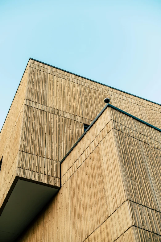 a tall building with a clock on top of it, an album cover, inspired by Peter Zumthor, unsplash, bamboo wood, close up shot from the side, espoo, wide angle exterior 2022