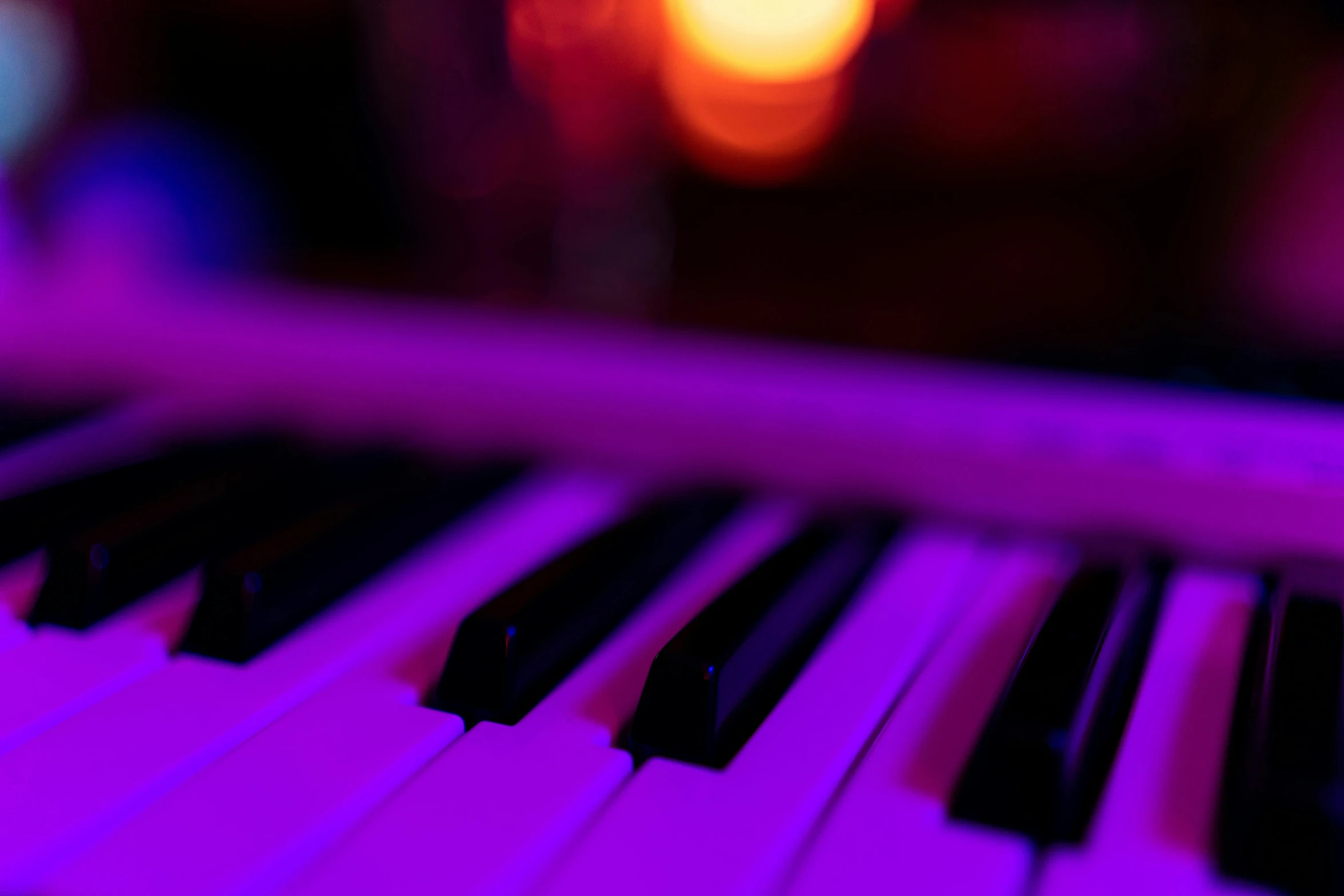 a close up of a piano keyboard with a blurry background, by Matt Cavotta, unsplash, romanticism, purple neon light, candlelit, 15081959 21121991 01012000 4k, bright glowing instruments