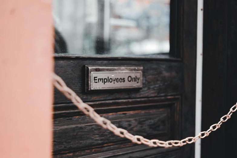 a sign on a wooden door that says employees only, by Arabella Rankin, trending on pexels, private press, chains, grey, rectangular, thumbnail