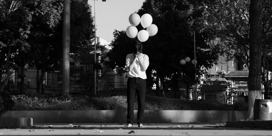 a black and white photo of a person holding a bunch of balloons, a black and white photo, unsplash, sad man, outside on the ground, ffffound, animation