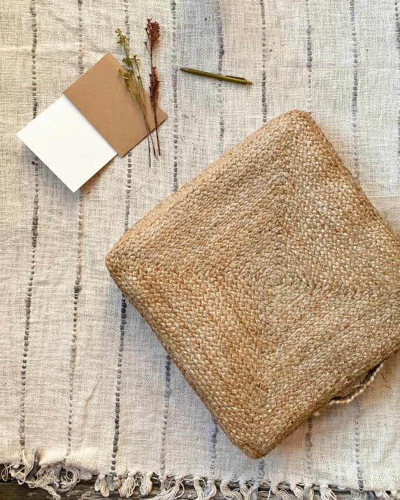 a piece of cloth sitting on top of a table, an album cover, by Helen Stevenson, unsplash, wicker art, in suitcase, wide angle shot from above, natural materials