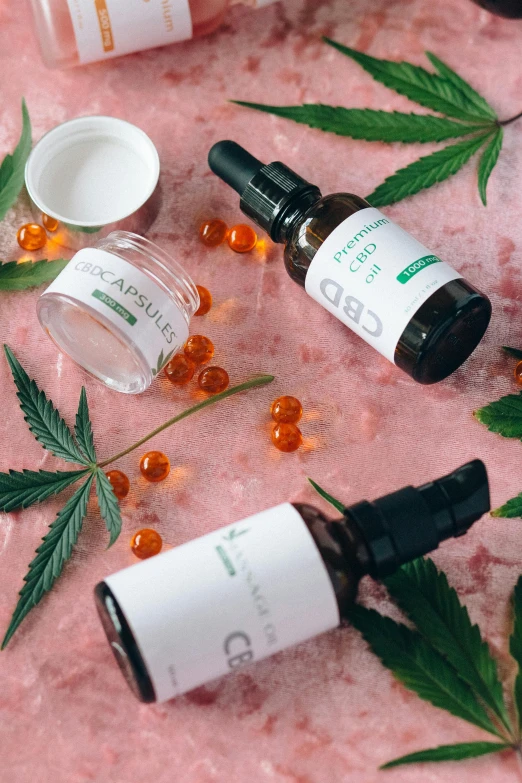 cbd products laid out on a pink surface, by Julia Pishtar, renaissance, on a white table, indigenous, 3 heads, thumbnail