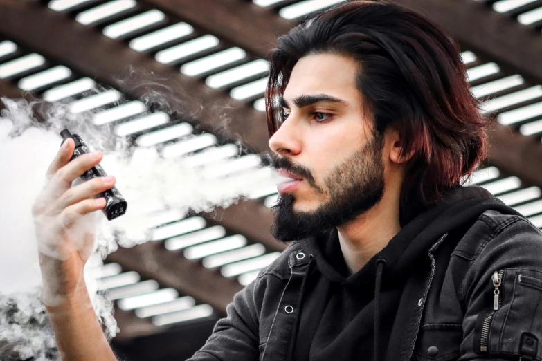a man with a beard smokes an electronic device, trending on pexels, hurufiyya, profile pic, orelsan, liquid smoke twisting, avatar image