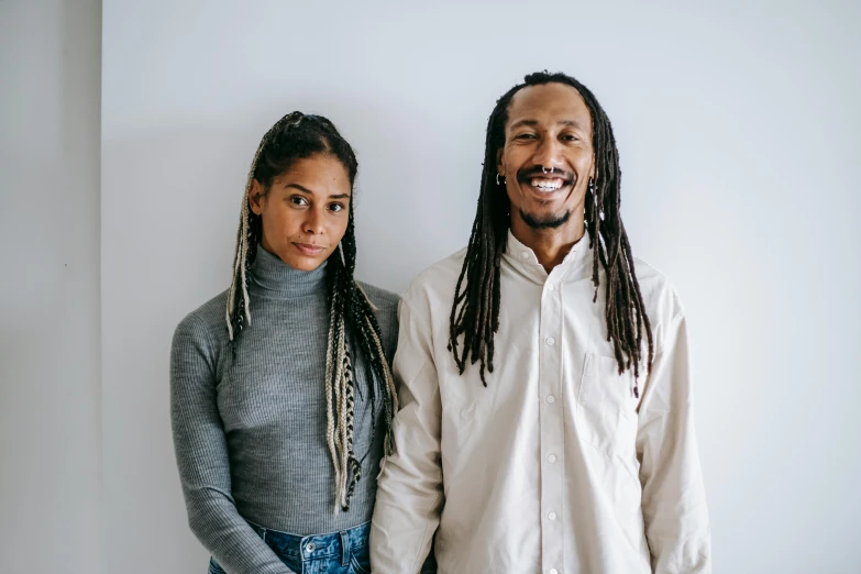 a man and a woman standing next to each other, pexels contest winner, black arts movement, dreadlock breed hair, in front of white back drop, thumbnail, light skin