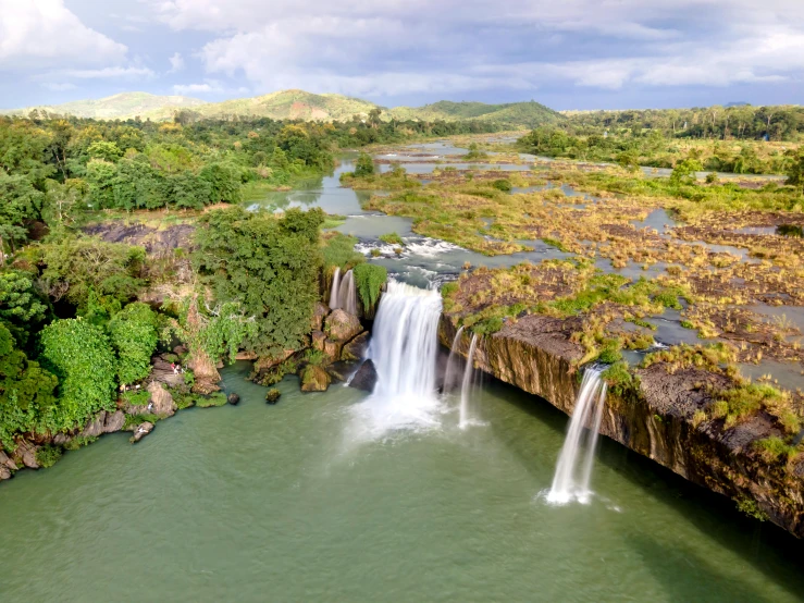 a waterfall in the middle of a lush green valley, an album cover, pexels contest winner, hurufiyya, nile river environment, panoramic shot, tropical location, drone photograpghy