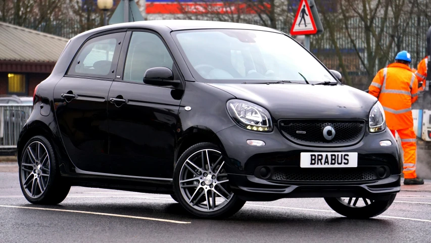 a smart car parked on the side of the road, a picture, by Joe Bowler, unsplash, square, main colour - black, detailed alloy wheels, fully frontal view