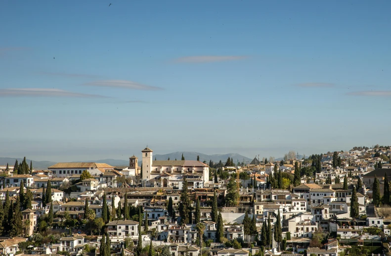 a view of a town from the top of a hill, by Alejandro Obregón, pexels contest winner, renaissance, sunny day time, moorish architecture, eero aarnio, seen from outside