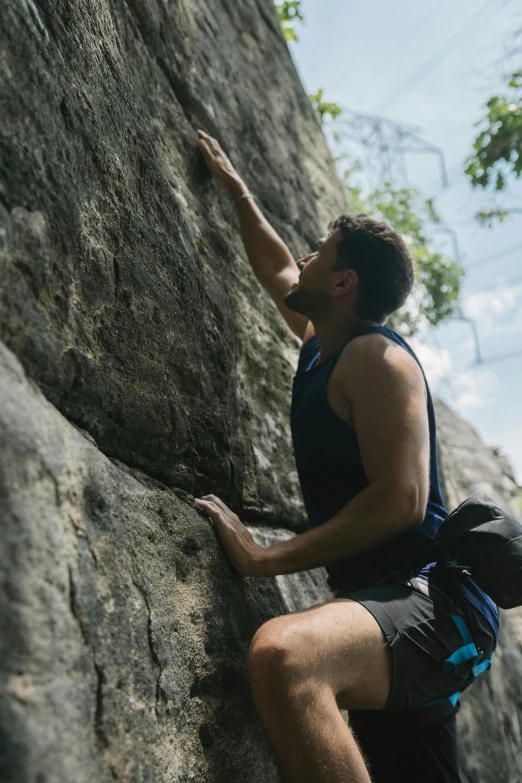 a man climbing up the side of a rock, pexels contest winner, renaissance, puerto rico, 30 year old man :: athletic, caught in 4 k, laos