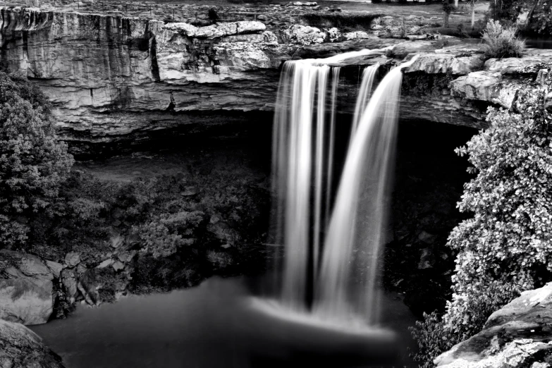 a black and white photo of a waterfall, by Randall Schmit, surrealism, alabama, taken in the late 2000s, ffffound, low exposure