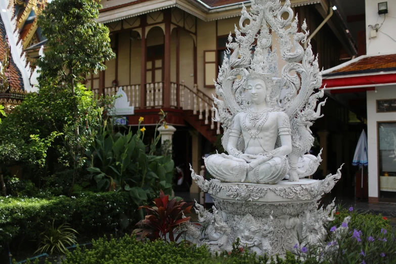 a white statue sitting in the middle of a garden, bangkok townsquare, ornate with white diamonds, from inside a temple, paradise garden massage