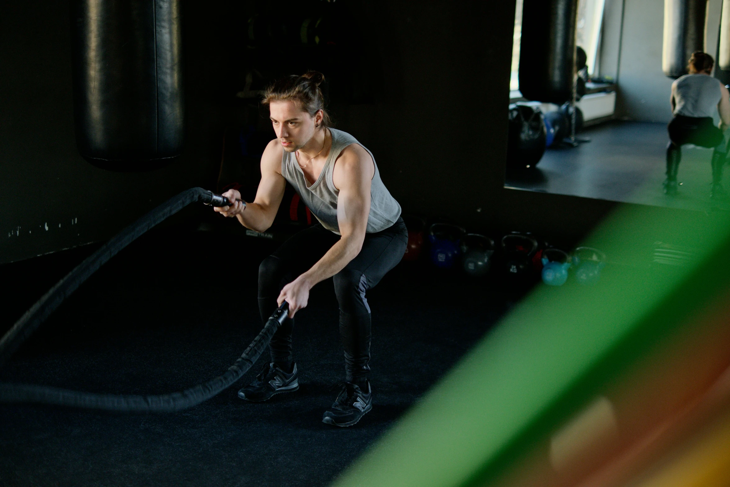 a man holding a rope in a gym, by Emma Andijewska, pexels contest winner, hurufiyya, looking left, profile image, lachlan bailey, flattened