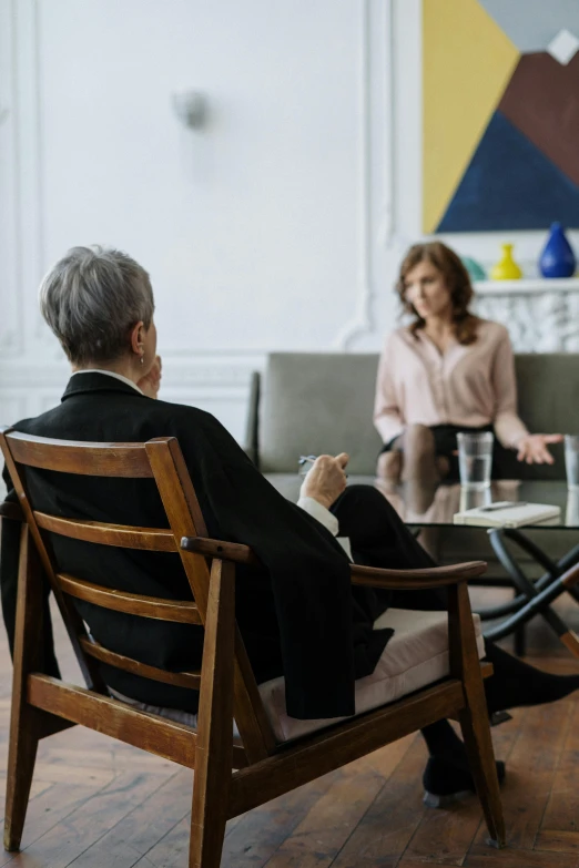 a group of people sitting around a glass table