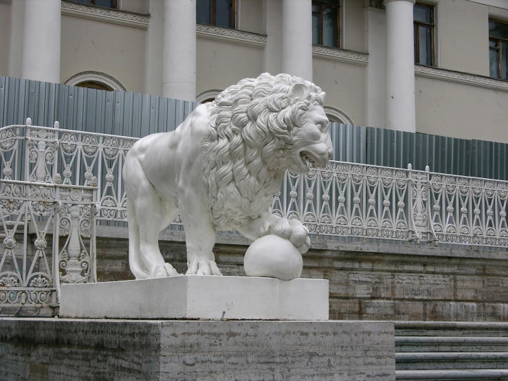 a statue of a lion with a ball in front of a building, white marble buildings, 3 4 5 3 1