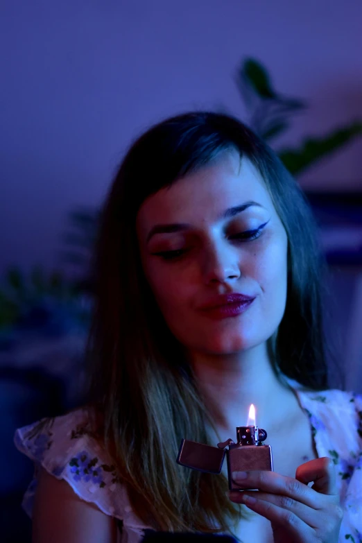 a woman holding a lit candle in her hand, inspired by Elsa Bleda, pexels, woman's face looking off camera, celebrating a birthday, profile image, film movie still