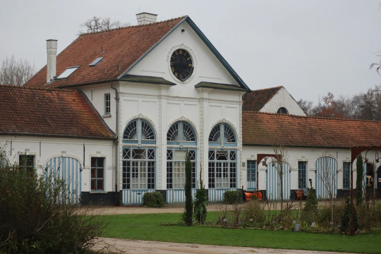 a large white building with a clock on top of it, inspired by Schelte a Bolswert, barbizon school, cyan shutters on windows, of augean stables, dutch style, ornate dining hall