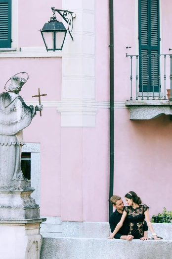 a woman sitting on a wall next to a statue, a statue, by Cagnaccio di San Pietro, (pink colors), kissing together, square, cimbri